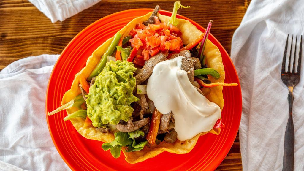 Fajita Salad · Grilled beef or chicken on mixed greens with tomatoes, salsa, sour cream & guacamole in a tortilla bowl