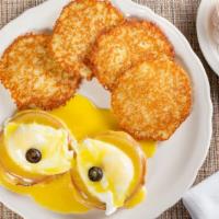 Eggs Benedict · A toasted english muffin topped with canadian bacon, poached eggs and homemade hollandaise s...