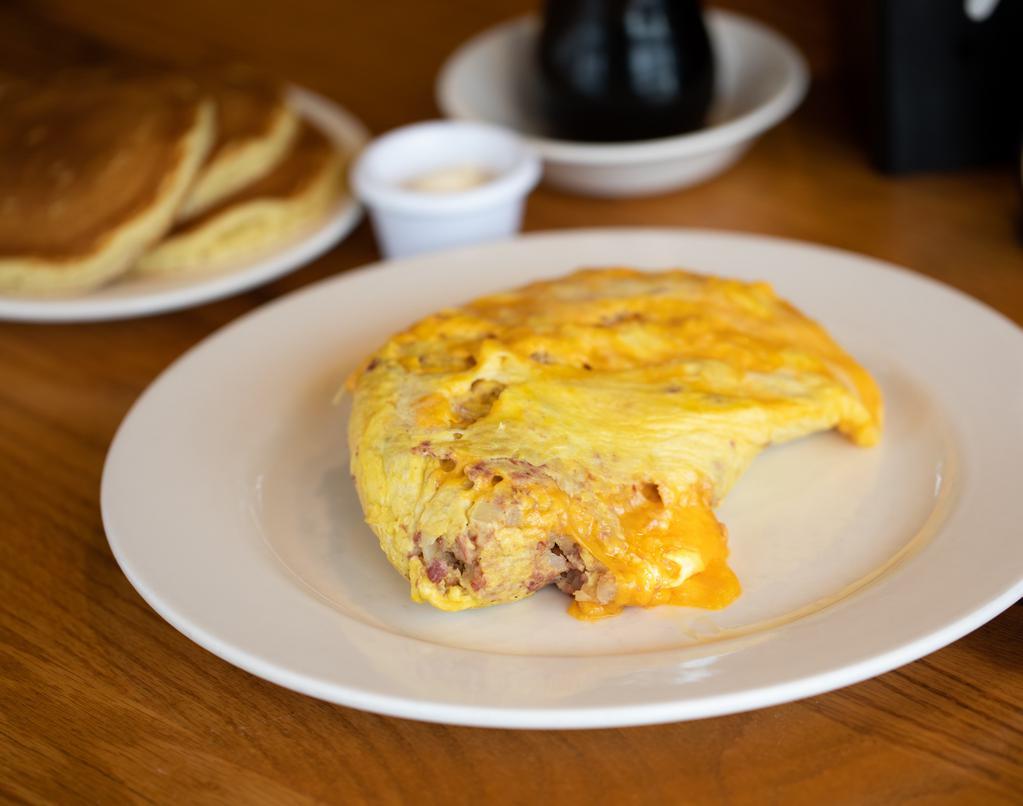 Irish Omelette · Stuffed with yellow cheddar cheese and our house-made hash, a blend of kosher corned beef, potatoes and onions. (1,960 Cal.)