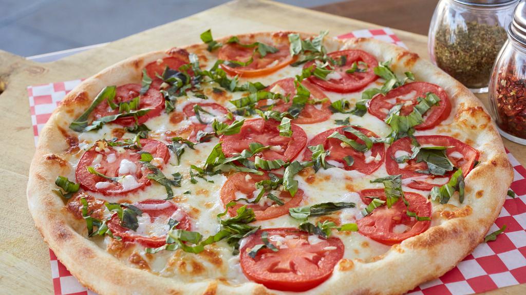 Margherita Thin Crust Pizza · Mozzarella, Roma tomatoes, garlic and fresh basil. No sauce.