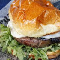 Smoked Mozzarella Burger* · Smoked mozzarella, roasted tomatoes, caramelized onion, arugula, chive aioli, brioche bun.