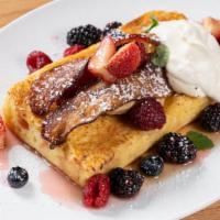 Juliette Brioche French Toast · with vanilla bean syrup, crispy bacon, fresh berries, whipped mascarpone cream, and our toas...