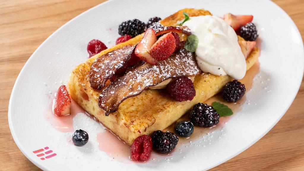 Juliette Brioche French Toast · with vanilla bean syrup, crispy bacon, fresh berries, whipped mascarpone cream, and our toasted brioche bread