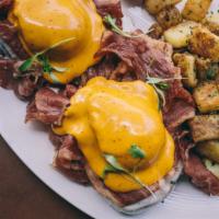 Reuben Benedict · Poached eggs, toasted whole wheat bread, corned beef, Swiss cheese béchamel, and spicy tomat...