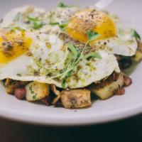 Corned Beef Hash · Buttery crispy potatoes, thinkly sliced corned beef, fresh herbs, topped with two sunny-side...