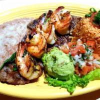Mar Y Tierra · Garlic shrimp & ranchero Steak. Served with rice,beans, guacamole & pico de Gallo.