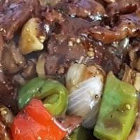 Sizzling Black Pepper Beef · Spicy. Tender beef sautéed with mushroom, green pepper, onion in black pepper sauce on sizzl...
