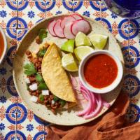 Taco + Consommé · Choice of taco with a side of tomato spice broth.