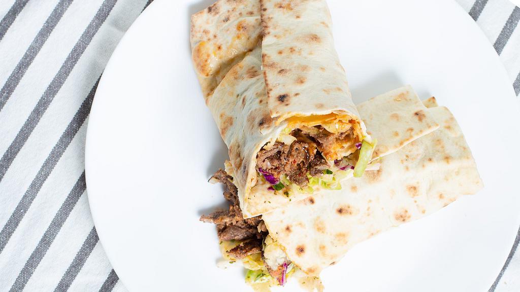 Beef Shawarma Wrap · Pita wrap with your choice of cabbage salad. Served with pickles and chili peppers. All shawarma wraps include cabbage salad, lettuce, and house shawarma sauce inside.