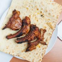 Pork Ribs Skewer · Four generous pieces of pork ribs. Served with a side of bread and garnish (red onion and ci...