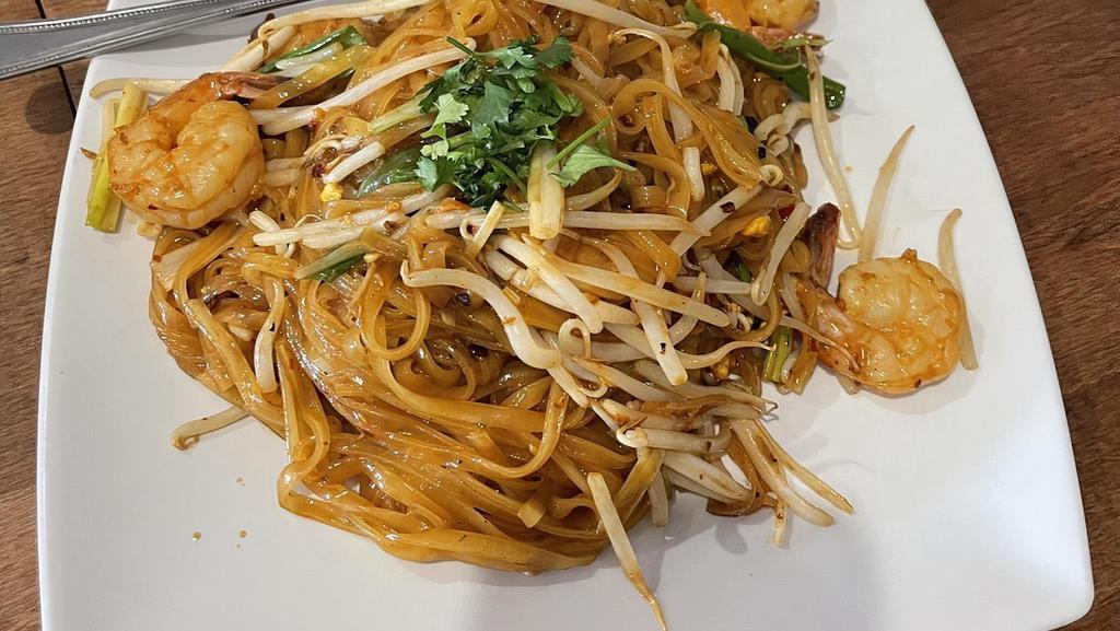 Pad Thai · Thin rice noodles pan fried with tamarind juice, egg, bean sprouts, green onions, and peanuts.