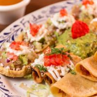 Frida Platter · A sampler platter with crispy chicken and potato taquitos, cheese quesadillas, mini sopes an...