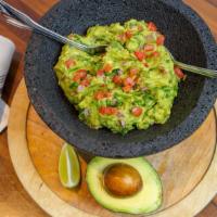Guacamole En Molcajete · Frida's Favorite! Fresh avocado  mixed with onions, jalapeño chile, tomato, cilantro and fre...