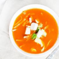 Sopa De Tortilla · This soup combines flavors and textures of tortilla strips, garnished with avocado, cheese, ...