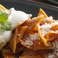 Chilaquiles · Crispy tortillas, mild red sauce, black beans or pinto beans, Jack cheeses, onion, sour cream.