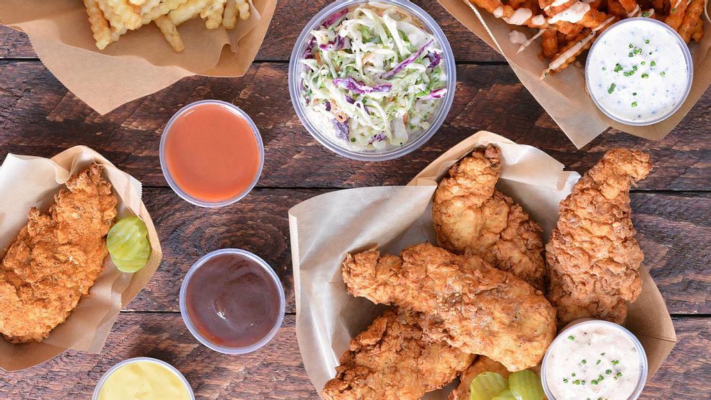 25 Tendies Tenders Party Box · 25 pieces of Tendies’ famous jumbo, buttermilk herb marinated, double hand-breaded chicken tenders with tangy coleslaw, fries, pickles and choice of sauces and seasoning.