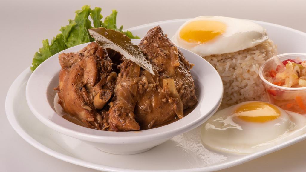Chicken Adobo Combo · Chicken braised in vinegar, soy sauce, garlic, and black peppercorn. Served with steamed rice and a sunny-side-up egg, over-medium.