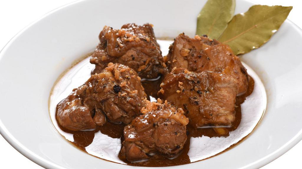 Chicken Adobo · Chicken braised in vinegar, soy sauce, garlic, and black peppercorn.  A filipino favorite!   Serving for one to two.