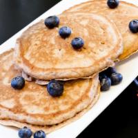 Blueberry Pancakes · Three fluffy protein pancake with blueberries inside.