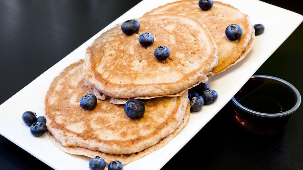 Blueberry Pancakes · Three fluffy protein pancake with fresh blueberries.