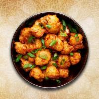 Cauliflower Manchurian · Crispy fried cauliflower florets are tossed in a spicy sauce with green onions and an Indo-C...