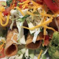 Taquitos · Beef, guacamole, sour cream, and salsa verde.