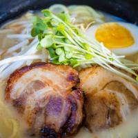 Tonkotsu Ramen · Ramen noodles, pork chashu, halved egg, topped with green onion served in a creamy port broth