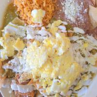 Chilaquiles With Egg · (Chiliquiles Con Huevo) Covered in Red or Green sauce with eggs, onions, sour cream, fresh c...