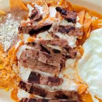 Super Chilaquiles  · Covered in Red or Green sauces: Comes with rice, beans, steak and eggs (Arroz, frijoles, car...