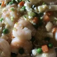 Shrimp With Lobster Sauce Over Rice · Sauteed shrimp in a white garlic and egg lobster sauce with peas, carrots, and mushrooms ser...