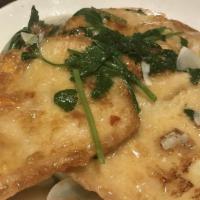 Garlic Baked Fish Filet · Fish filets served over a bed of bok choy in a white garlic sauce.