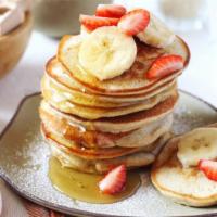 Vanilla Pancakes · Airy, fluffy and delicious flavored pancakes with strawberry, banana, blueberry, and powdere...