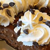 German Chocolate Slice · Chocolate cream, coconut and chopped pecans over a layer of chocolate. Topped with fresh whi...