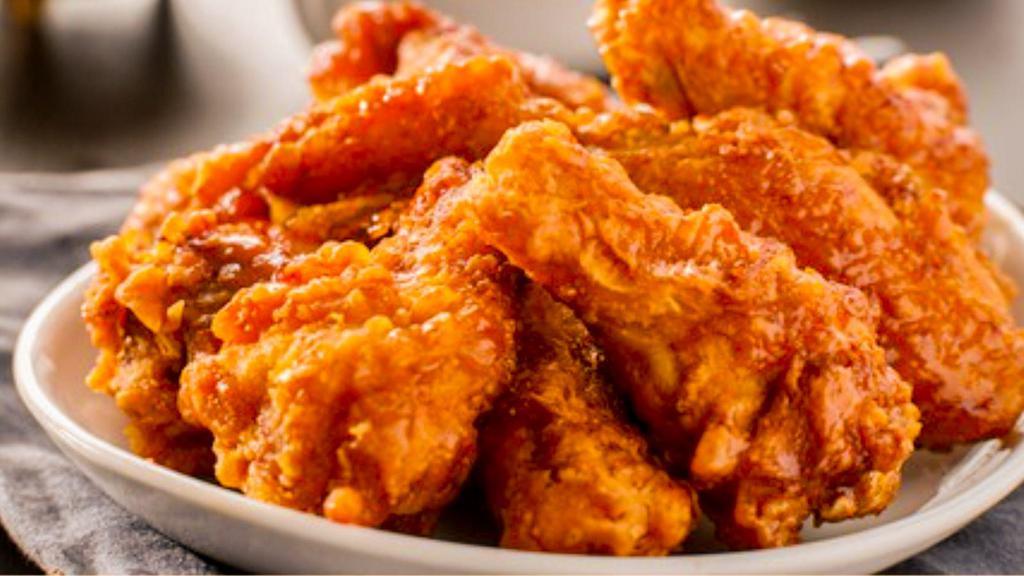 Buffalo Wings (6 Pieces) · Golden, fried, crispy on the outside, juicy on the inside wings glazed with classic, spicy, vinegar based Buffalo sauce. Served with celery and carrot sticks and your choice of dip.