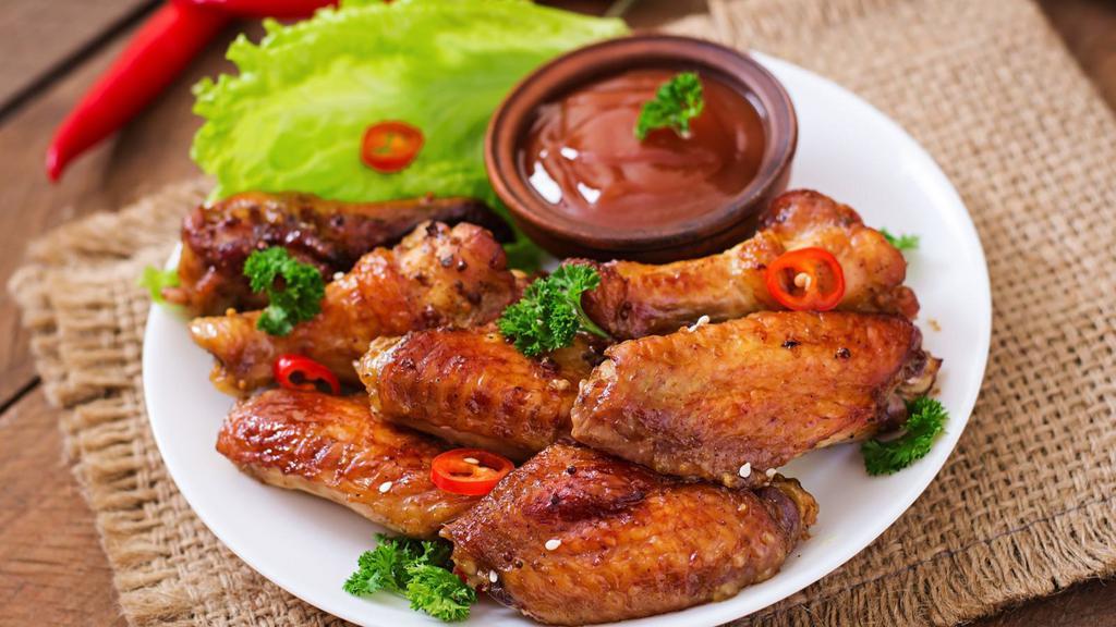 Teriyaki Wings (6 Pieces) · Golden, fried, crispy on the outside, juicy on the inside wings glazed with tangy and sweet Teriyaki sauce. Served with celery and carrot sticks and your choice of dip.