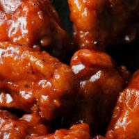 Smoky Bbq Wings · Crispy oven roasted wings topped with smoky BBQ sauce.