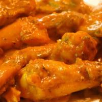 Spicy Mango Habanero Wings · Crispy oven roasted wings dipped in spicy mango habanero sauce.