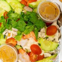 Tasty Thai Salad · Fresh lettuce, cabbage, carrots, onions, cilantro, cucumbers, and tomatoes. Topped with stea...