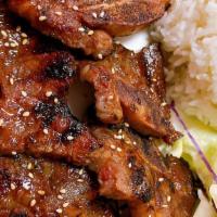 Galbi · Marinated beef short ribs with rice and salad