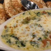 Artichoke Dip · Artichoke, spinach and pepperoni baked with cream and italian cheese, served with garlic toa...