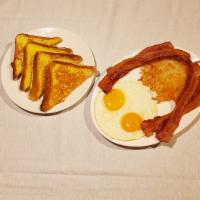 French Toast Combo Breakfast · Choice of  Ham,  Bacon, or  Sausage, Serve with 2 Eggs, Hash Brown Potatoes and French Toast.