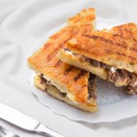 Bulgogi Sandwich · Marinated sliced ribeye, grilled onions, provolone cheese, and mayo spread.