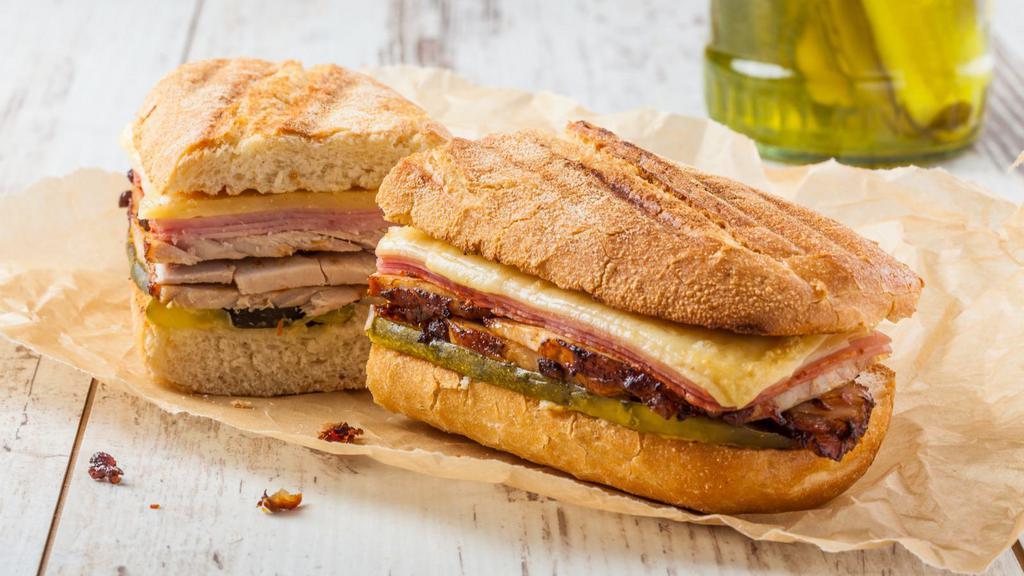 Yummy Cuban Sandwich · Fresh turkey ham, juicy pork belly, swiss cheese, mayonnaise, mustard and pickles.