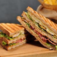 Classic Club Sandwich · Juicy ham, turkey, crispy bacon, avocado, lettuce and tomato.