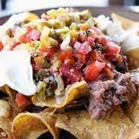 Super Nachos · Crispy tortilla chips, your choice of meat, beans, cheese and guacamole.