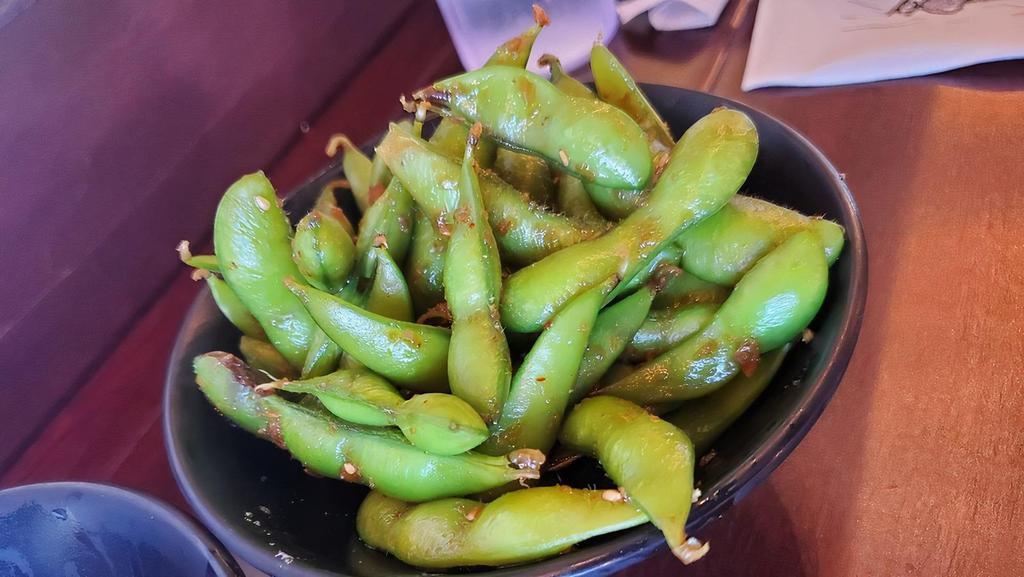 Garlic Edamame · Blanched soybeans tossed in a mixture of fresh ground garlic, sesame, soy sauce and light chili flakes.