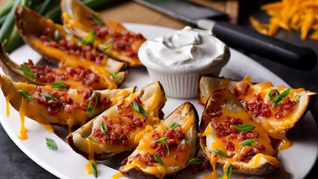 From-Scratch Loaded Potato Skins · Made-from-scratch with bacon, cheddar cheese and green onions.