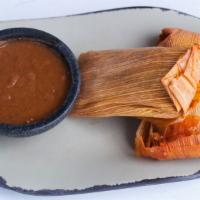 Chicken Tamales (2) · Fresh masa, seasoned chicken, roasted spicy red sauce