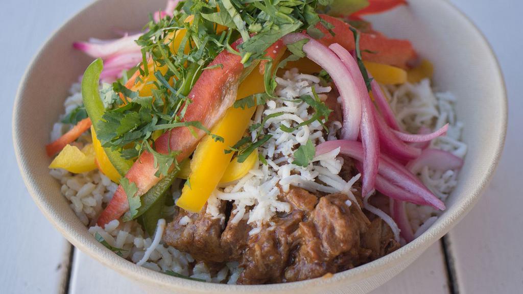 Braised Short Rib · Slow-braised ancho short ribs, cotija cheese, pickled onions, cilantro, brown rice, peppers, red sauce.