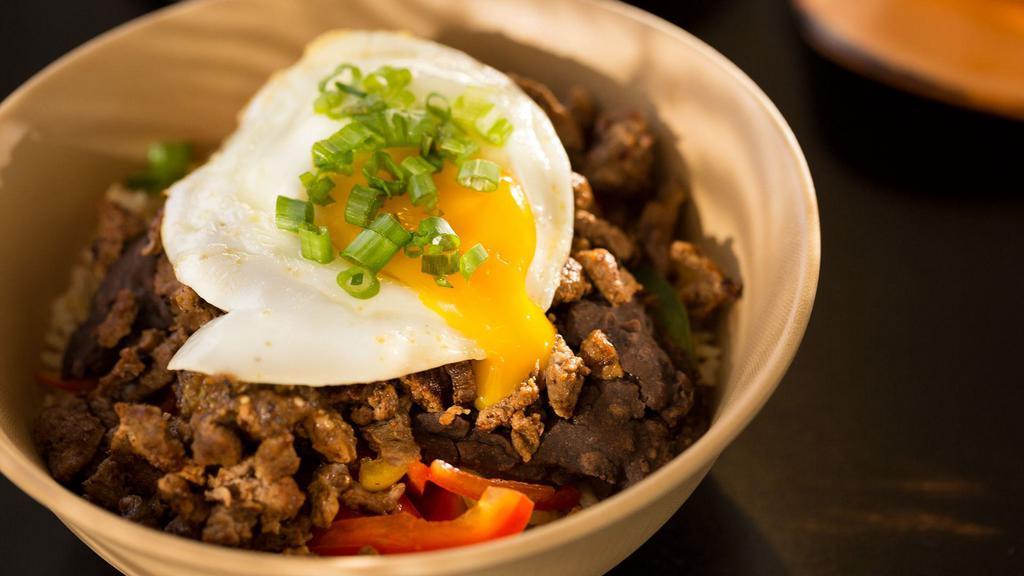 Steak & Egg · Chili lime-marinated steak, black bean puree, roasted tomato salsa, brown rice, peppers, red sauce.